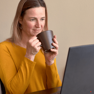 lady on a laptop having a coffee