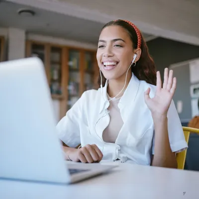lady on a computer waving